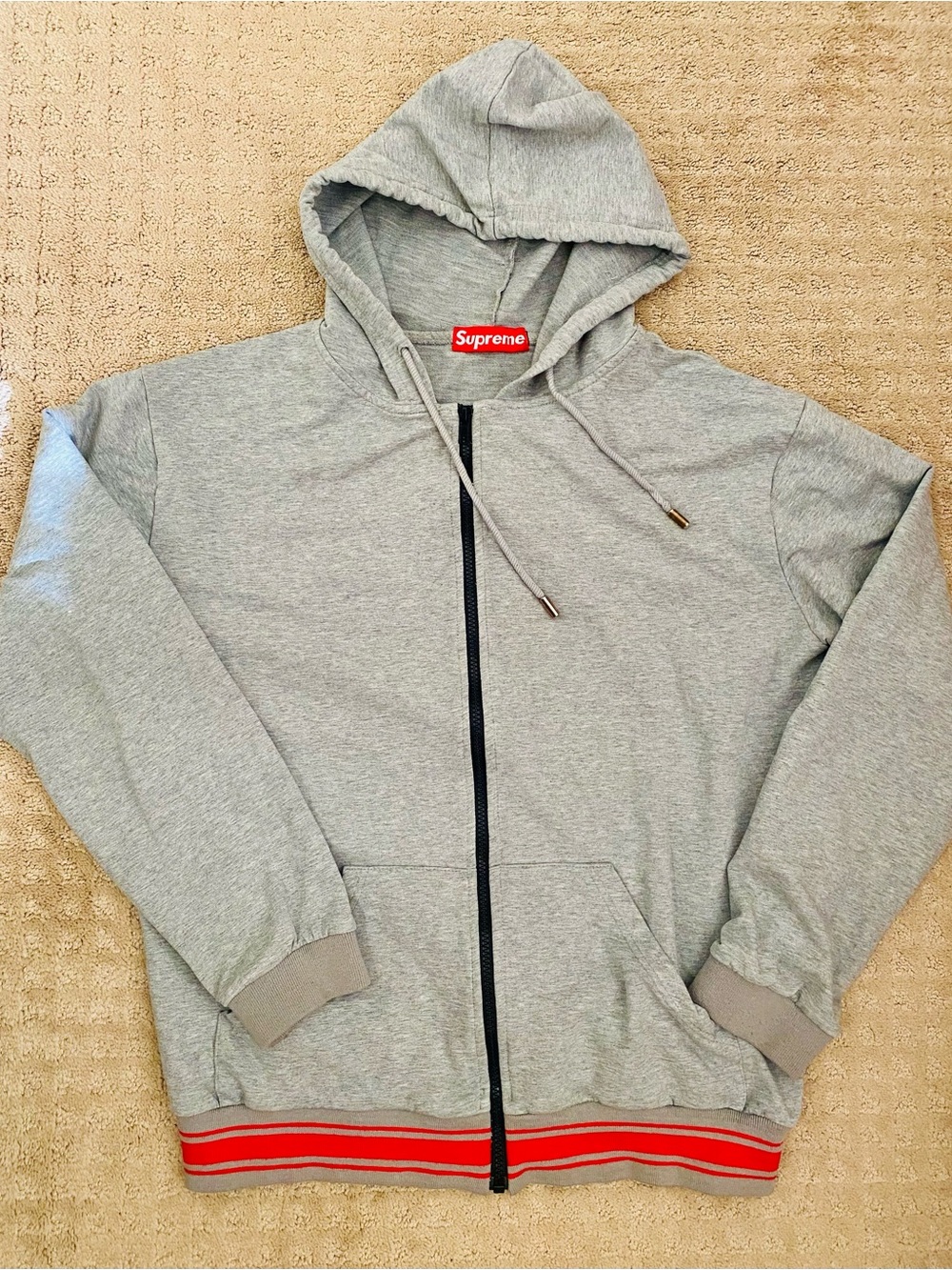 Supreme Light Gray Zip-Up Hoodie with Black Zipper and Red Hem Stripes